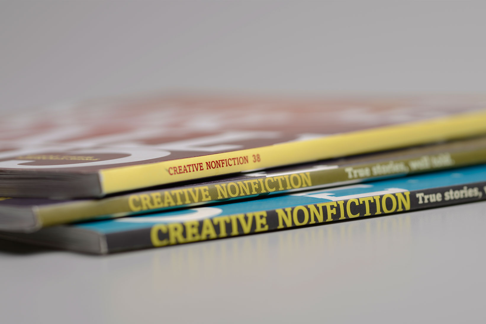 Stack of Creative Nonfiction Magazine showing the spines
